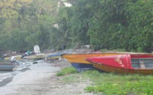 Man repairing boat at Lances Bay